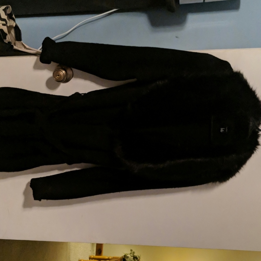 Black knit sweater with attached faux fur collar.